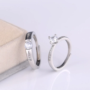 Detail of silver couple rings with cubic zirconia and adjustable open bands