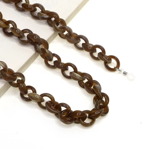 Close-up of amber acrylic chunky chain glasses strap with translucent tortoiseshell links