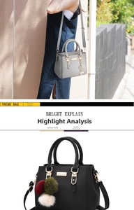 Detail of trendy shoulder bag with litchi grain leather and fluffy pompom keychain