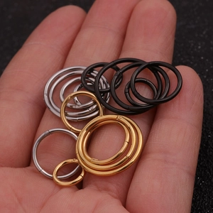 Minimalist stainless steel hoop piercings in black, gold, and silver in various sizes