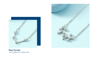 Detail view of two minimalist zodiac necklaces with sparkling zircon stones in silver finish