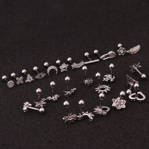 Detailed set of silver stainless steel studs featuring star, moon and flower shapes