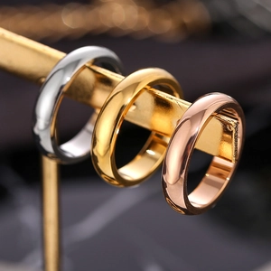 Minimalist wide band stainless steel rings in silver, gold, and rose gold finishes