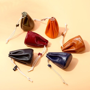 Retro oil wax leather coin purses in six colors with cream drawstrings on beige background