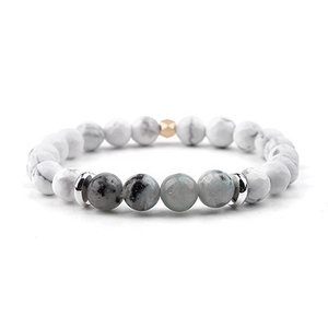 Detailed shot of moonstone beads with white marble textures and gold hexagonal spacers