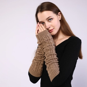 Detail of dark coffee cable knit arm warmers showing texture and fingerless design