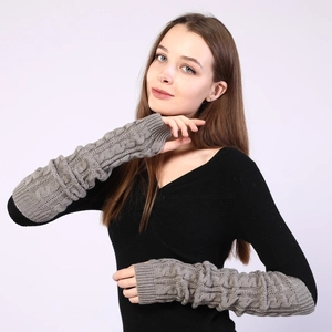 Detailed view of grey cable-knit texture on long fingerless wool gloves for women