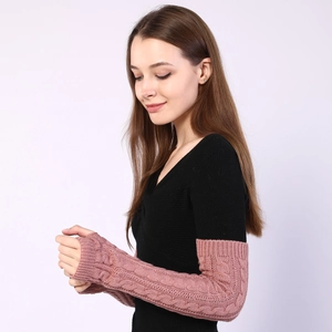 Detailed knit texture of long cable-knit arm warmers in a soft dusty rose pink color