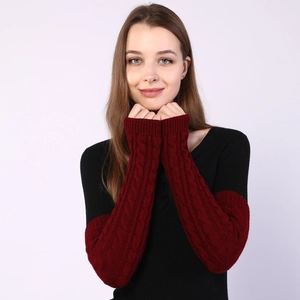 Detail showing cable knit texture and elastic cuff on burgundy arm warmer gloves