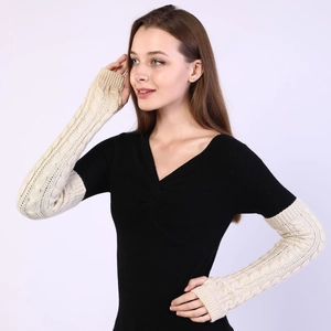 Close-up of beige knit arm warmers with classic cable knit texture for women