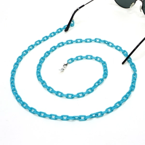 Macro detail of vibrant blue acrylic eyeglass chain with lobster clasps on white background