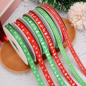 Christmas ribbons with snowflake and reindeer prints on a festive wooden tray