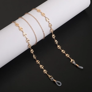 Chaîne de lunettes dorée avec breloques couronne et boucles antidérapantes sur support