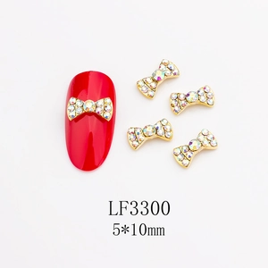 Dettaglio charm unghie LF3300 fiocco oro 5x10mm con strass AB per manicure fai-da-te