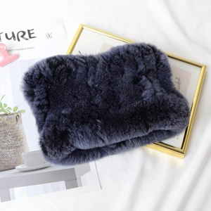 Detailed texture of dark purple rex rabbit fur scarf on an artistic display background