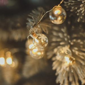 Nordic LED Christmas glass ball lights with snowflake pattern on warm glowing bulbs