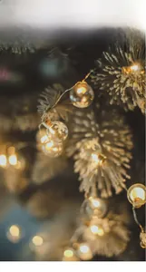 Close-up of Nordic Christmas glass ball LED light string with warm glow and snow texture