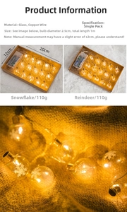 Detail of Nordic glass ball LED string lights with snowflake and reindeer patterns