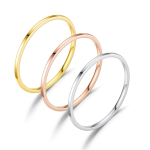 Three minimalist 1mm stainless steel bands in gold, rose gold, and silver colors