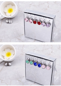 Macro view of multi-colored round cubic zirconia drop earrings with French hooks
