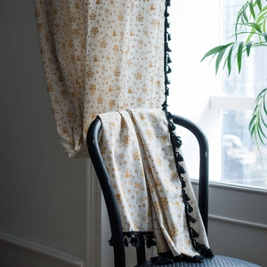 White cotton linen curtain with golden Christmas patterns and black tassel trim decor
