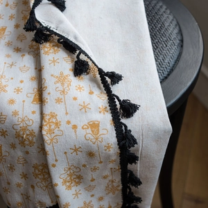 White linen curtain with gold Christmas bells pattern and black decorative tassels