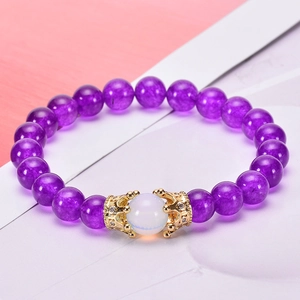 Pink quartz and hematite bracelet featuring a gold zircon crown bead on pastel background