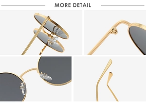 Detail view of round gold metal sunglasses featuring gray lenses and precision hinges