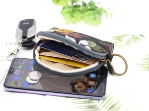 Floral fabric coin purse detail with bronze zipper, leather tag and key ring attachment