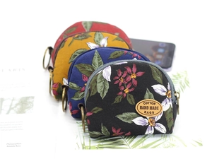 Detail of floral cotton coin purses with metal zippers and handmade leather labels