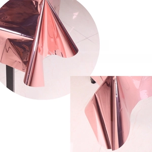 Detail of rose gold PET tablecloth showing reflective mirror surface and soft drape