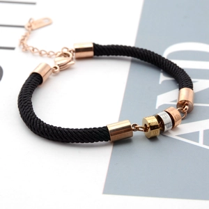 Black braided cord bracelet with three-tone rose gold rings and adjustable chain