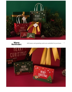 Close-up of Christmas gift box with gold ribbon and matching holiday greeting cards