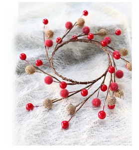 Detail of Christmas wreath featuring red berries, gold glitter fruits and brown branches