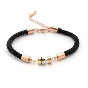 Three-tone tricolor interlaced rings on black braided rope bracelet with rose gold details