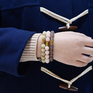 Bohemian natural stone beaded bracelet set with gold tubes on a model's wrist