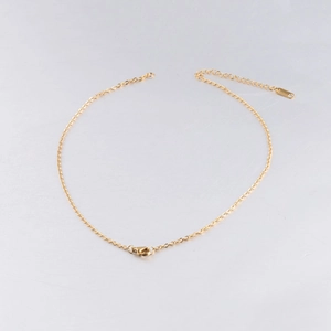 Detailed view of 2mm golden stainless steel cross chain with lobster clasp and extender