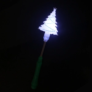 Detail of Christmas tree spring wand glowing with white light and green handle