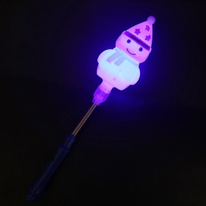 Close-up of a glowing snowman magic wand with spring neck and blue handle in the dark
