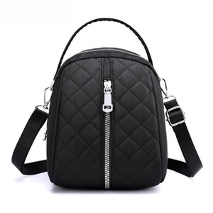 Detail of waterproof nylon waist bag showing black quilted pattern and front zipper