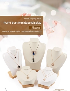 Macro detail of white microfiber portrait bust necklace display with wooden base