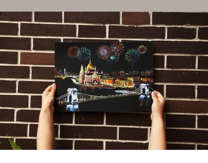 Macro shot of city night scratch art featuring castles, bridges and colorful fireworks