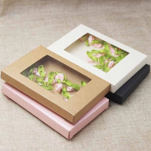 Detail of rectangular gift boxes with PVC windows in pink, kraft, white, and black colors