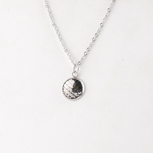 Detail of silver stainless steel necklace with 12mm round fish scale texture pendant