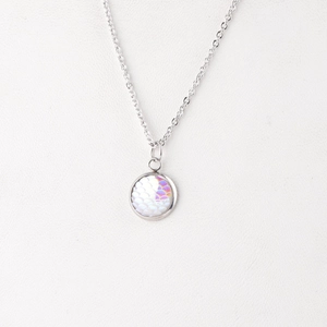 Detailed macro view of 12mm round mermaid scale pendant on a silver stainless steel chain