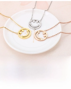 Détail de pendentifs smiley en acier inoxydable doré, argenté et or rose