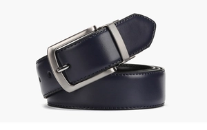 Detail of navy blue leather belt with silver brushed metal pin buckle on white background