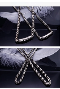 Macro view of vintage silver steel woven chain link with cylinder clasp detail