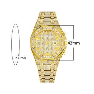 Detail view of gold iced-out watch with 42mm octagonal case and date window display