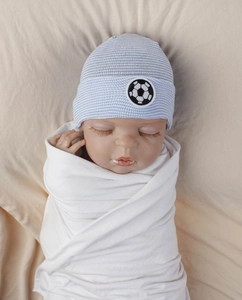 Detail of baby striped knit beanie featuring a soccer ball embroidery patch on a blue cap
